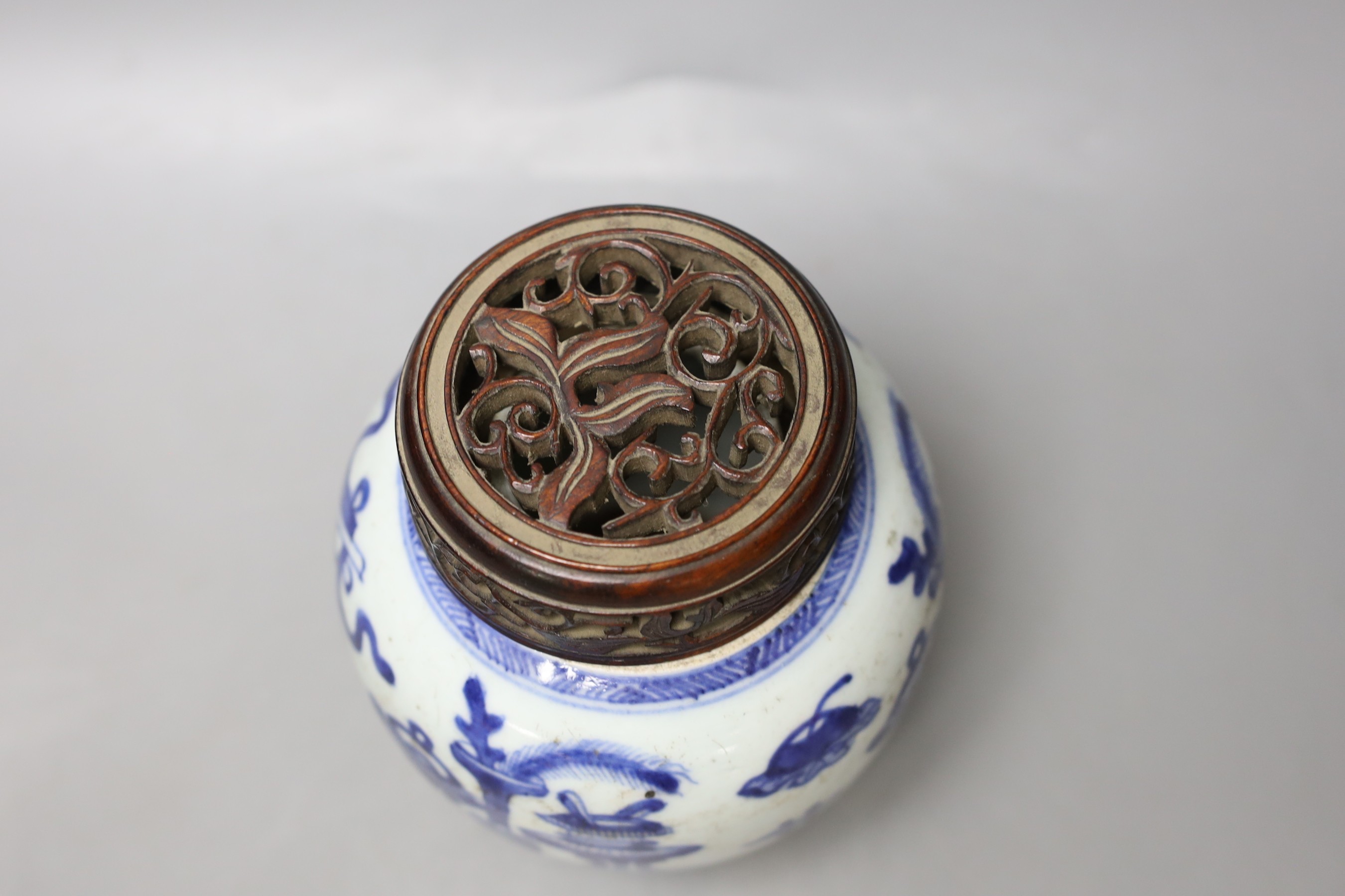 A 19th century Chinese blue and white jar with wood cover - 17cm high